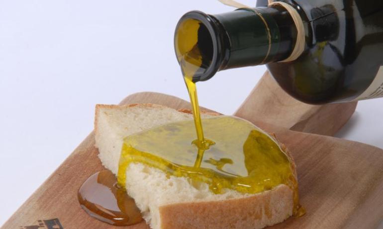 Bread with olive oil on a wooden board.